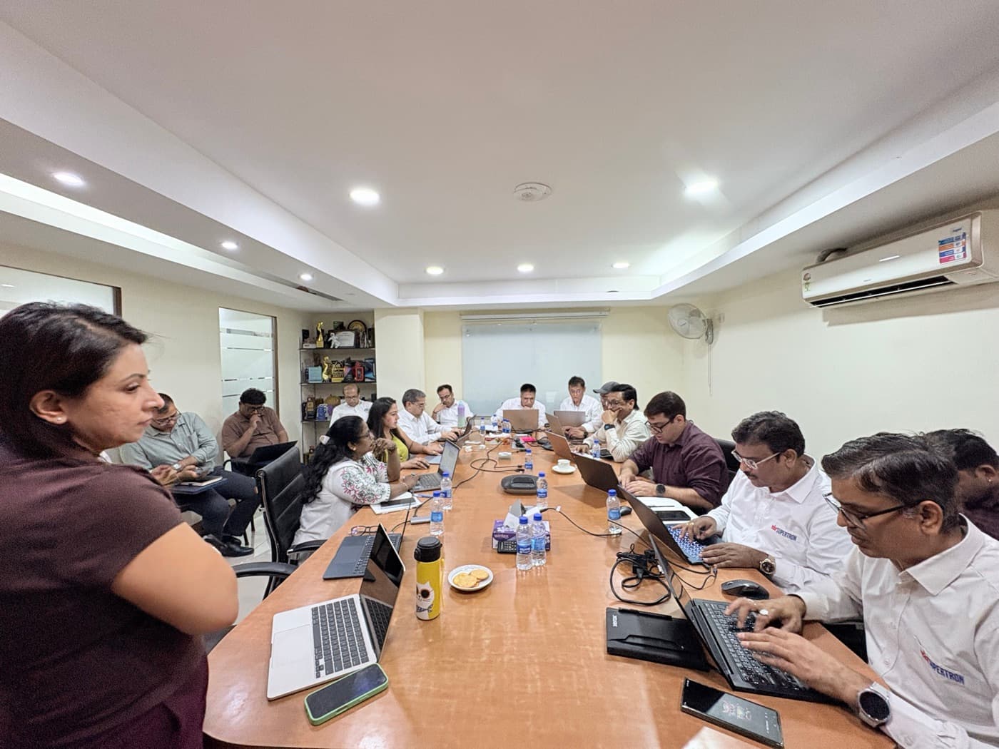 The full boardroom at Supertron Delhi, the sales team working on their own laptops