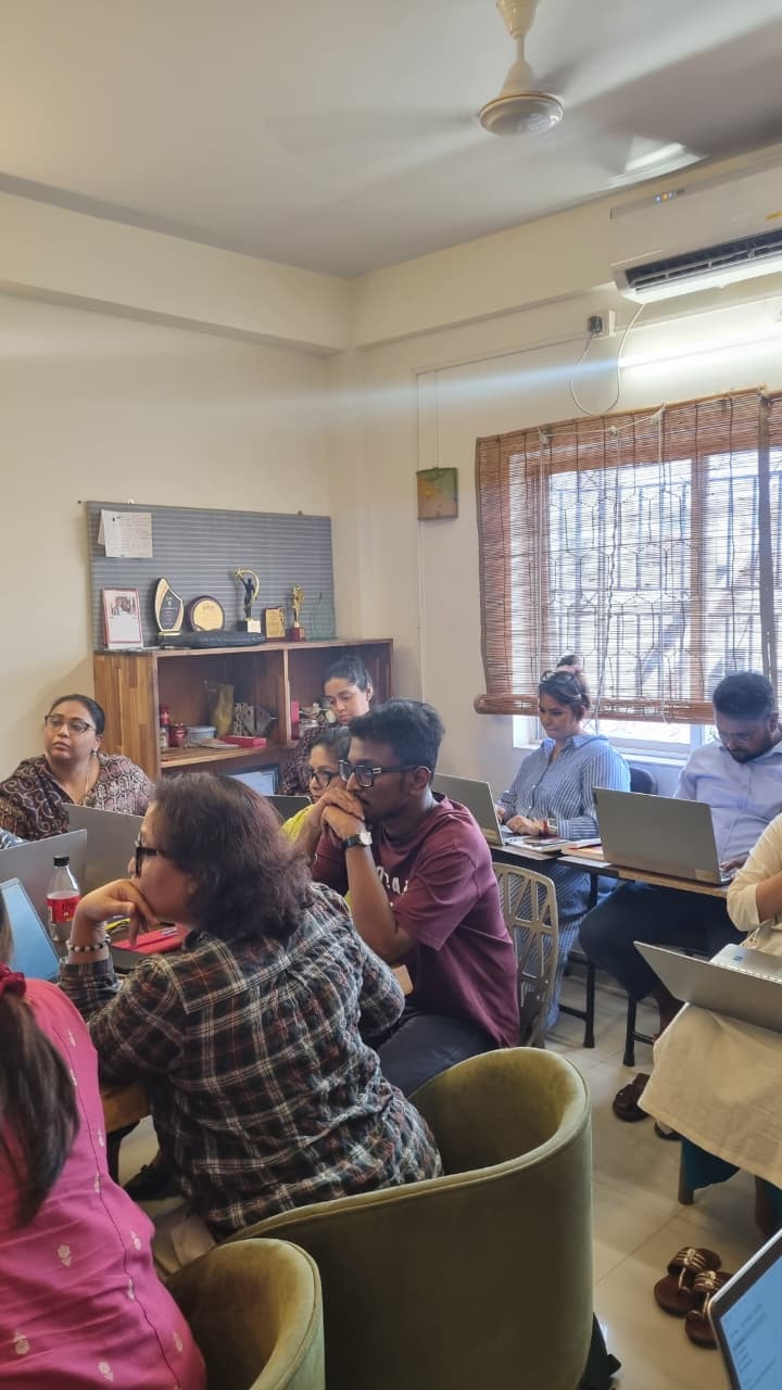 Participants listening partway through a session, laptops open in front of them